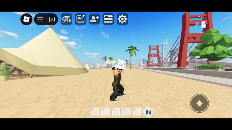 Roblox avatar on a beach near a bridge.