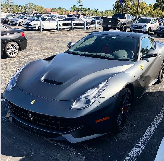 Gray Ferrari F12 in a parking lot.