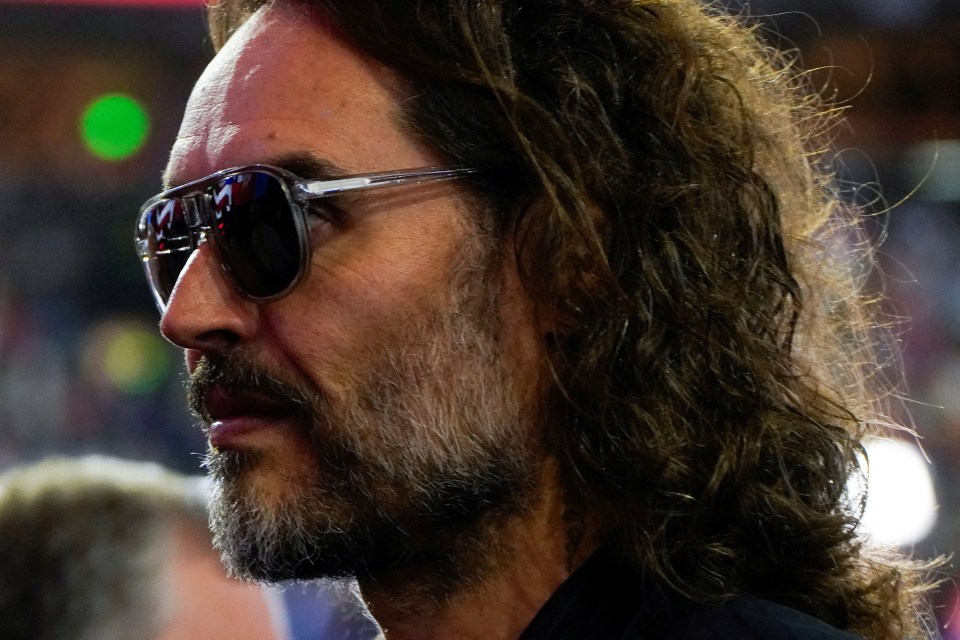 Close-up profile of Russell Brand wearing sunglasses.