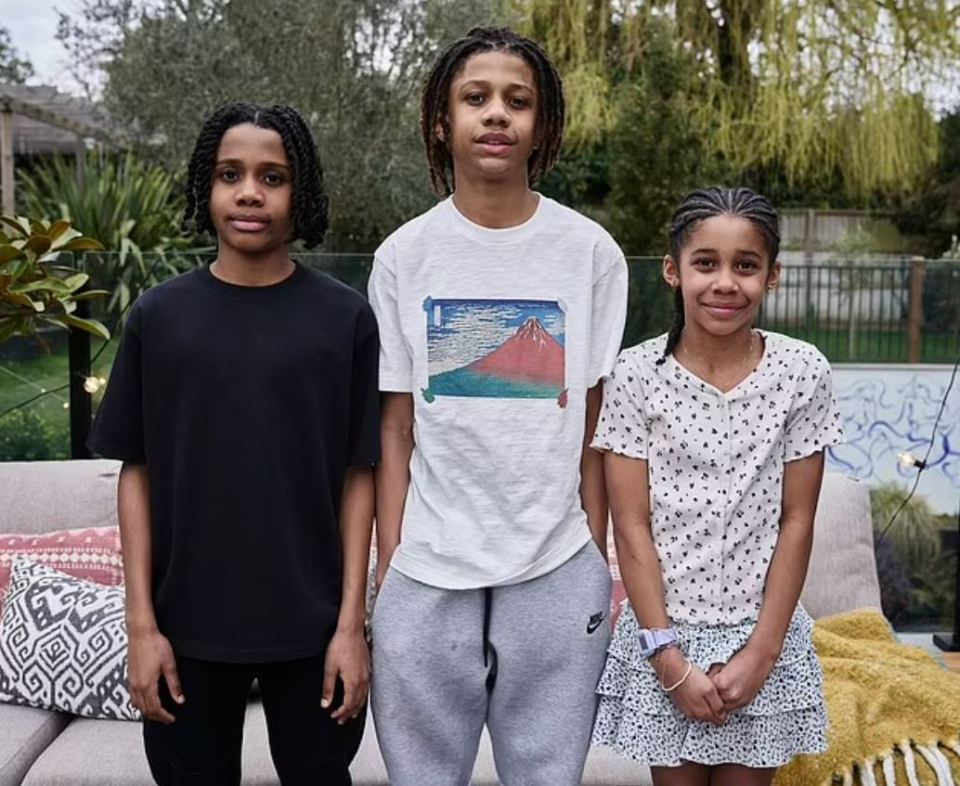 Three siblings posing for a photo.