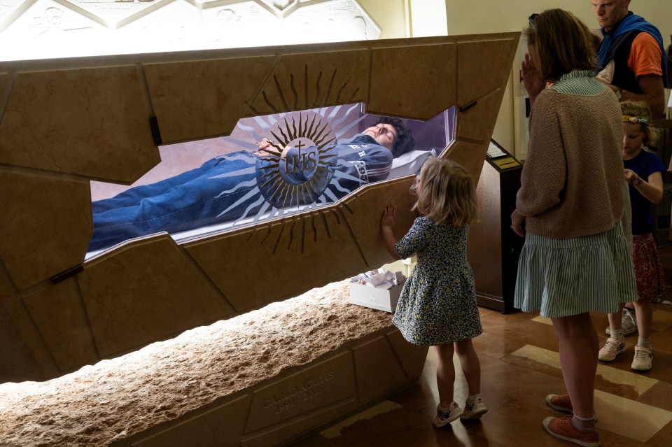 Visitors view the tomb of Carlo Acutis.