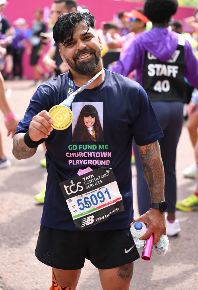 Runner holding London Marathon medal.