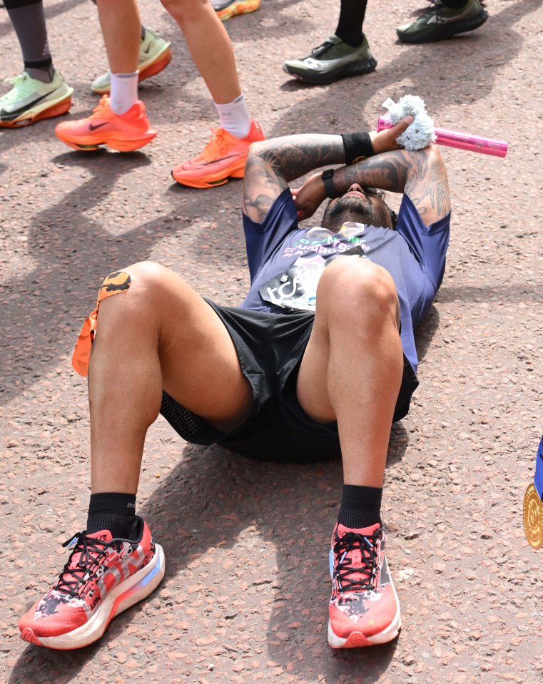 Runner resting on the ground after the London Marathon.