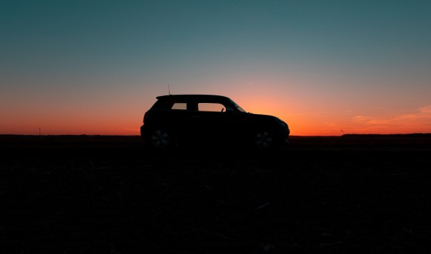 Silhouette of a small car at sunset.