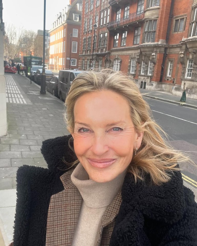 Jacquie Beltrao in a black coat, smiling.