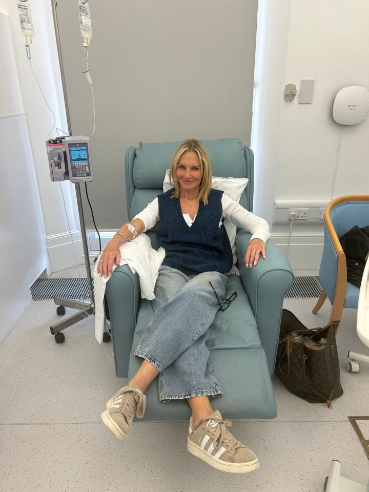 Woman receiving intravenous treatment in a medical facility.