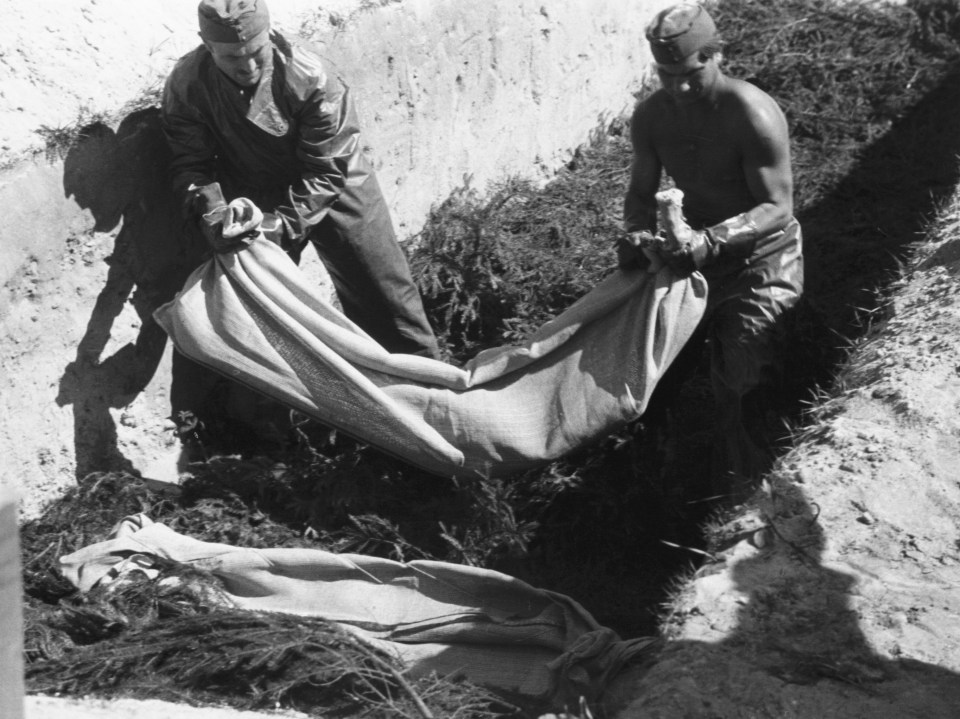 SS soldiers burying bodies at Belsen concentration camp after its liberation.