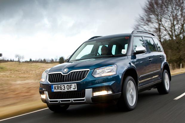 Dark-blue Skoda Yeti driving on a road.