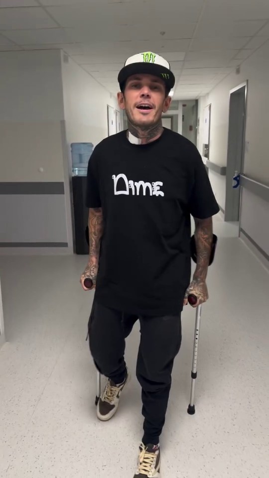 Man using crutches in a hospital hallway.