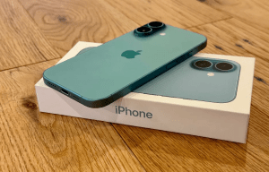iPhone 16 Plus in teal on its box.