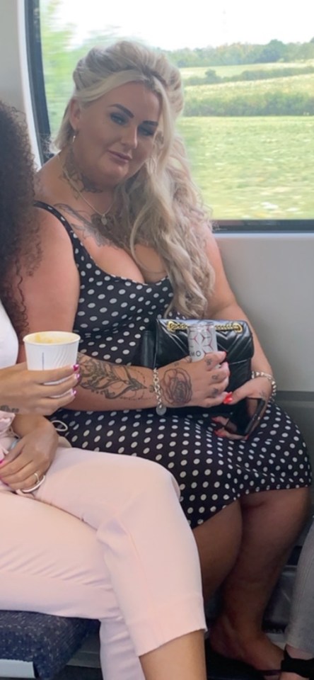 Woman in polka dot dress on a train.