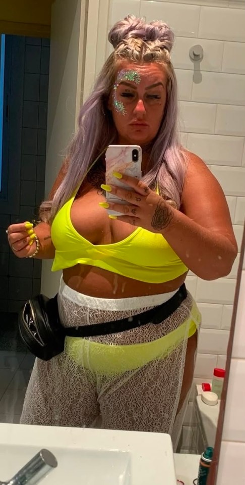 Woman taking a selfie in a bathroom mirror.