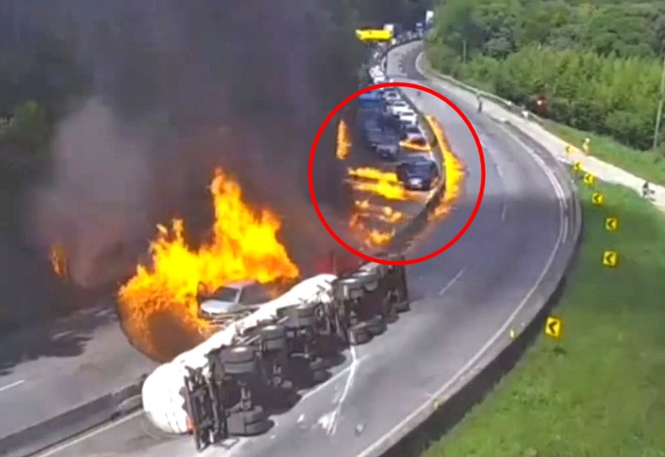 Video still of an overturned ethanol tanker truck on fire, igniting nearby vehicles.