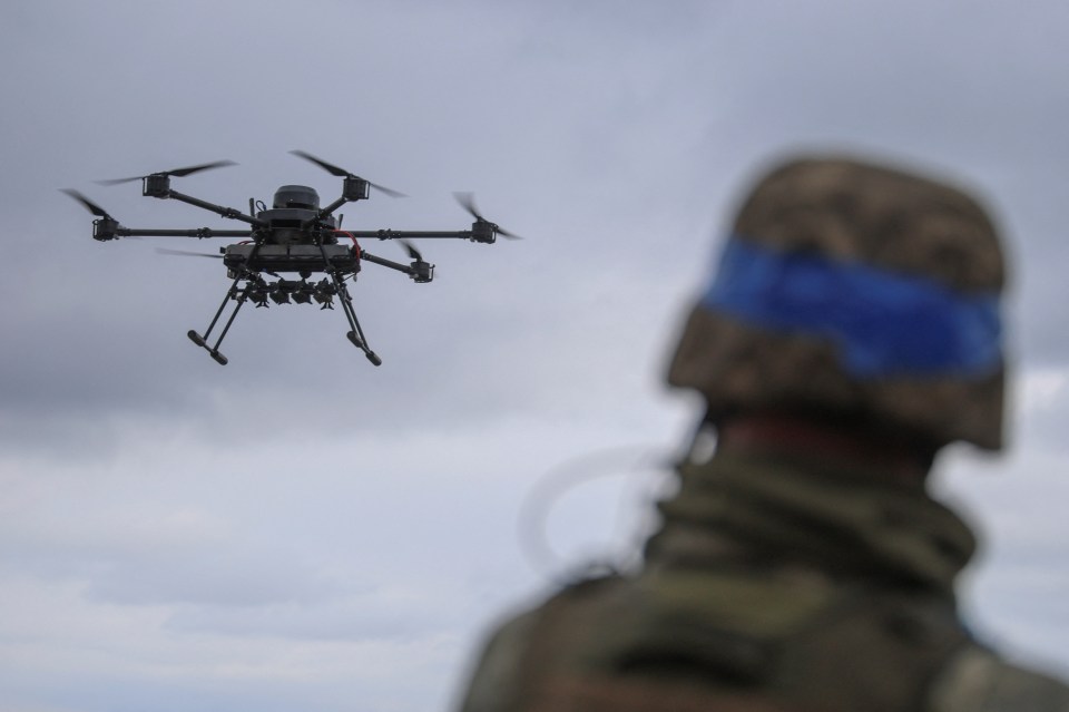Ukrainian serviceman observing a Vampire drone in flight.