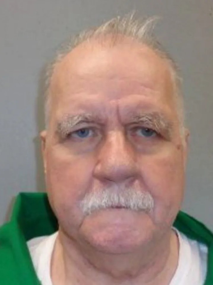 Mugshot of an older man with light-colored hair and a mustache.