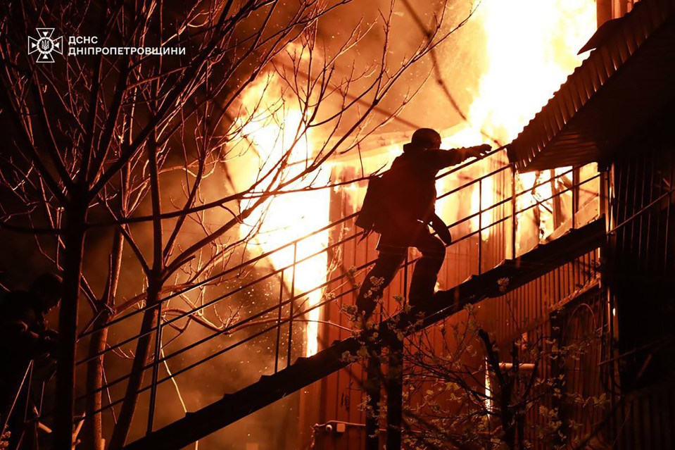Firefighter on stairs during a building fire.