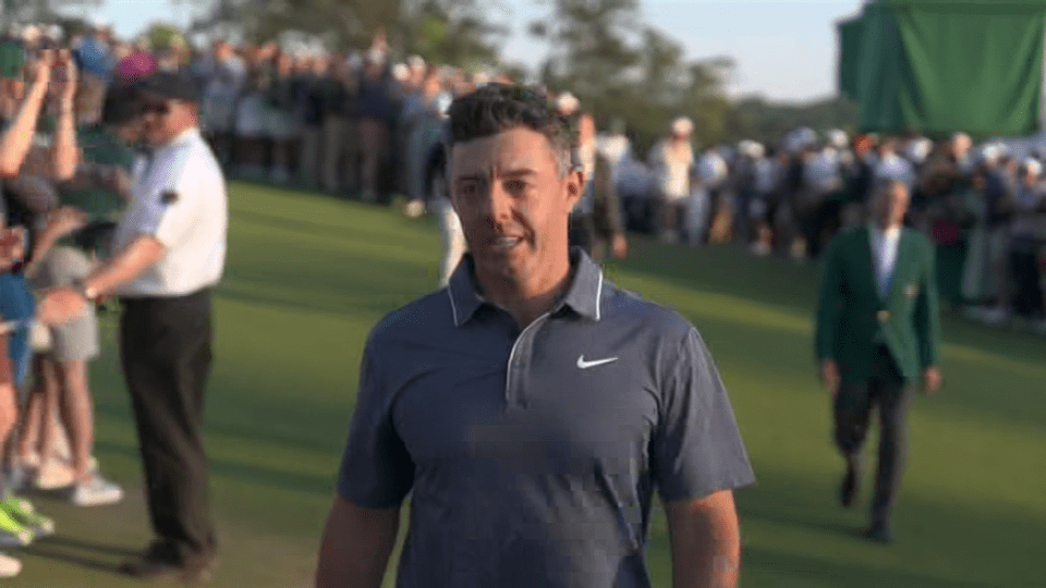 Rory McIlroy walking on a golf course.