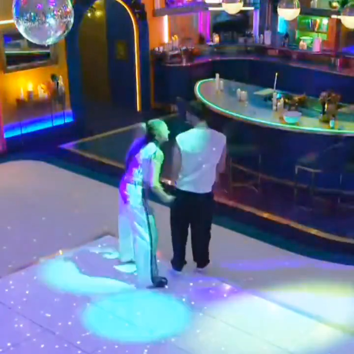 JoJo Siwa slapping Chris Hughes on a dance floor.