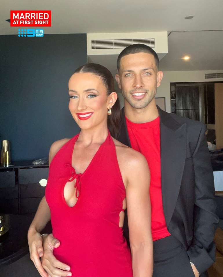 A couple in red and black attire.