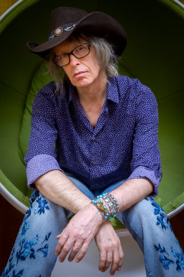 Mike Scott of The Waterboys, seated, wearing a cowboy hat.