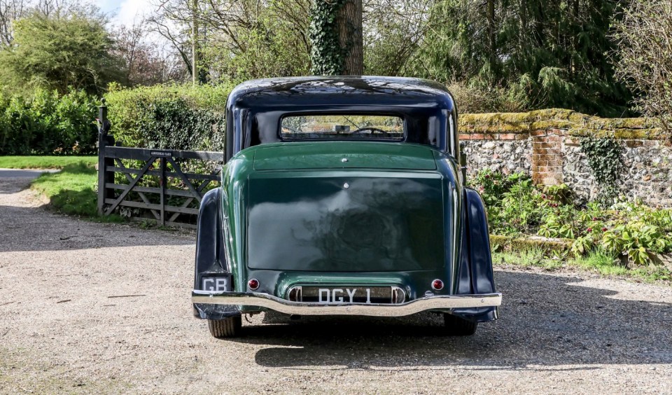Rear view of a dark green 1936 Rolls-Royce Phantom III Touring Limousine.