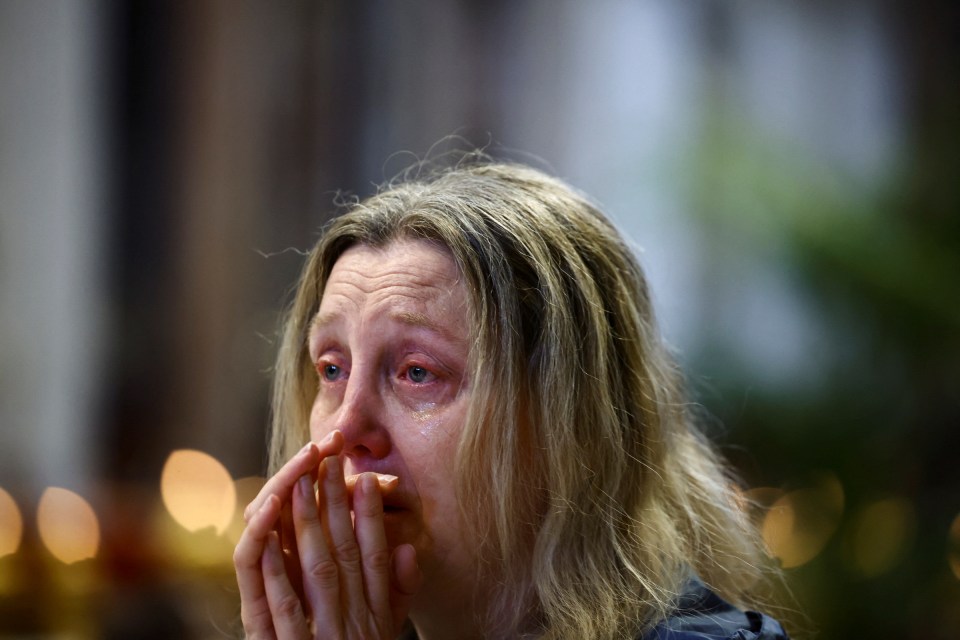 A woman reacts pas a nun during late Pope Francis' funeral ceremony, in central Rome on April 26, 2025. (Photo by Piero CRUCIATTI / AFP) (Photo by PIERO CRUCIATTI/AFP via Getty Images)