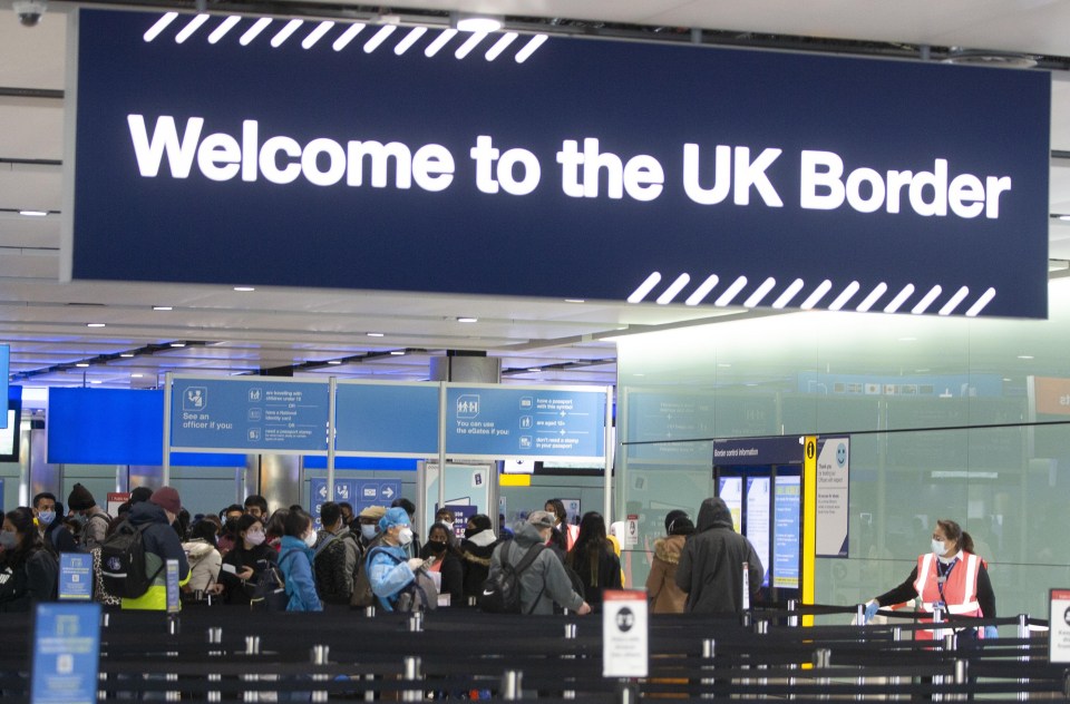 People queuing at UK border control.