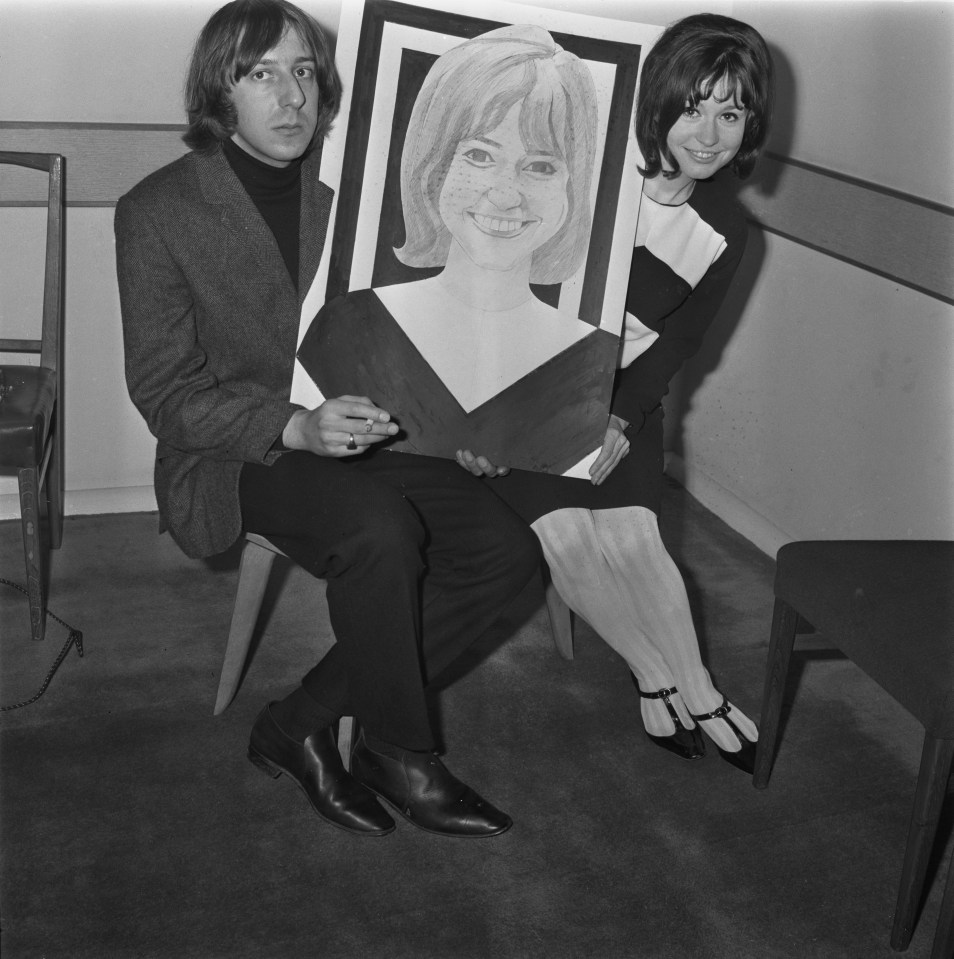 Black and white photo of Wendy Varnals and Barry Fantoni holding a portrait of Varnals.