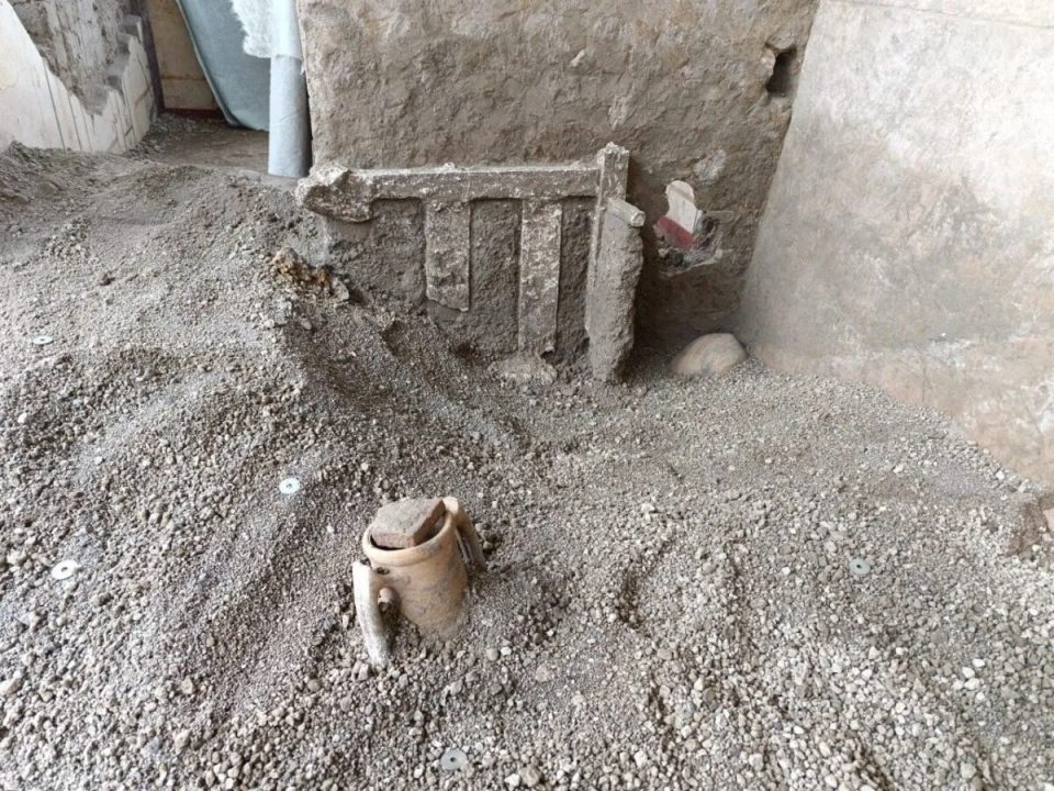 Pompeii excavation site showing a 2000-year-old bed used as a barricade.