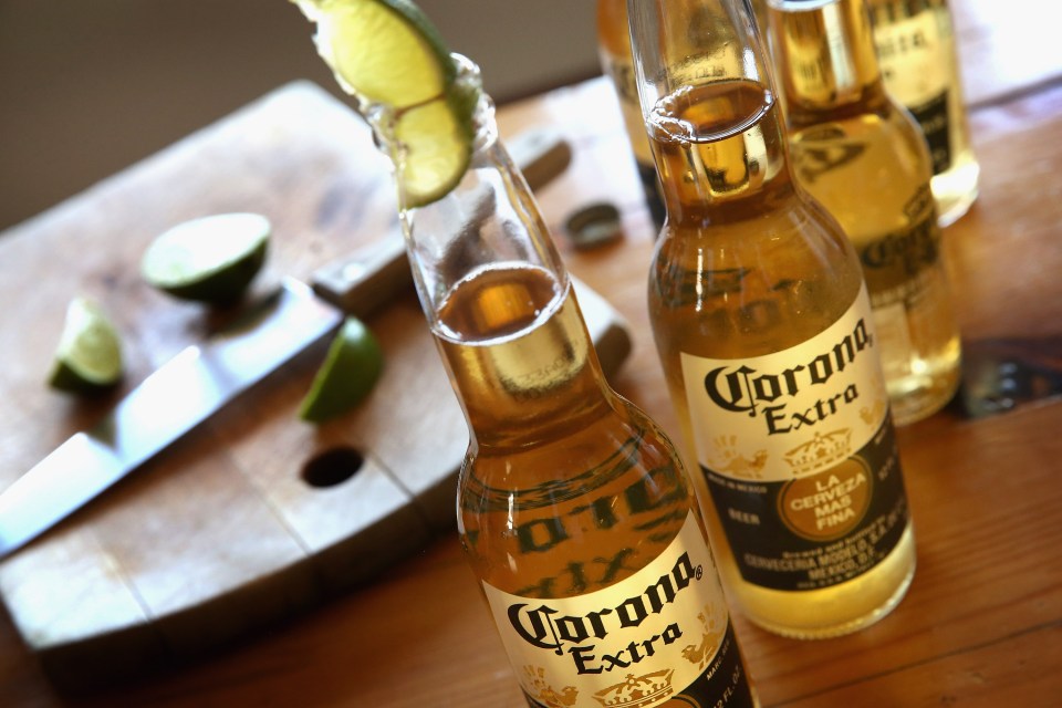 Photo illustration of Corona Extra beer bottles and lime wedges.