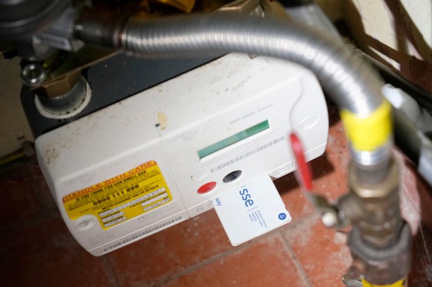 Photo illustration of a prepayment gas meter and card in a home.