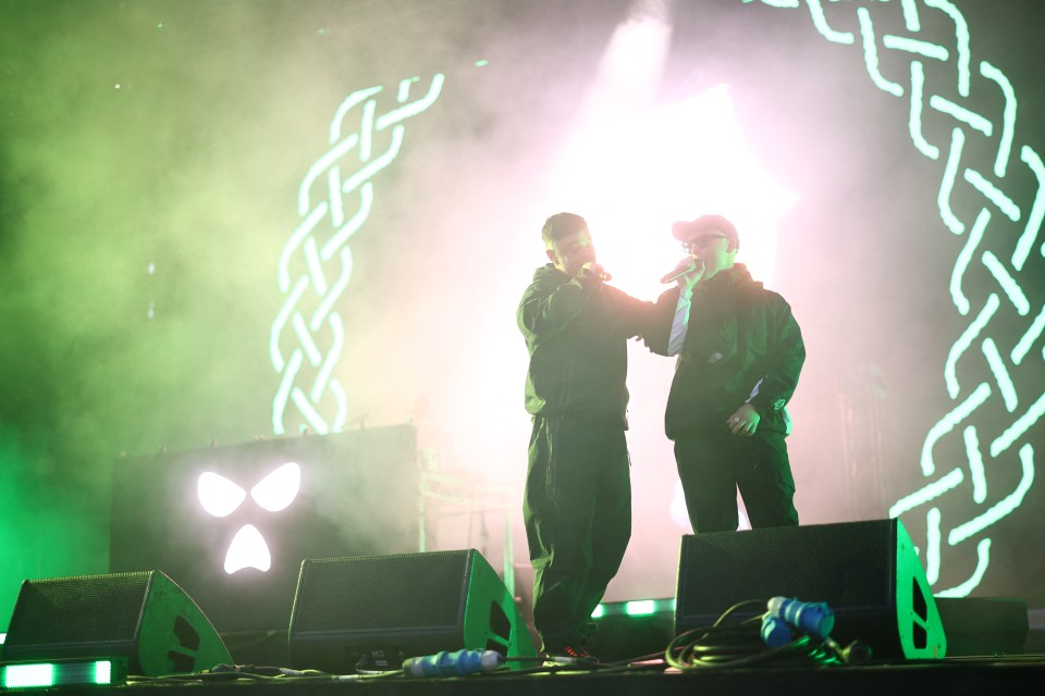 Kneecap, a Northern Irish hip hop trio, performing onstage.