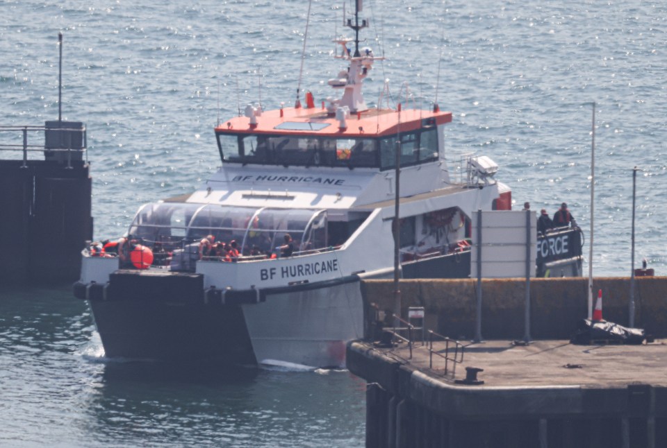 Boat carrying migrants arriving at port.