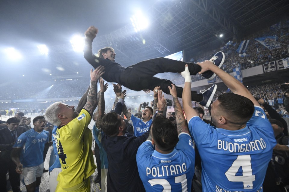 SSC Napoli players celebrating their Serie A title win by lifting their coach.