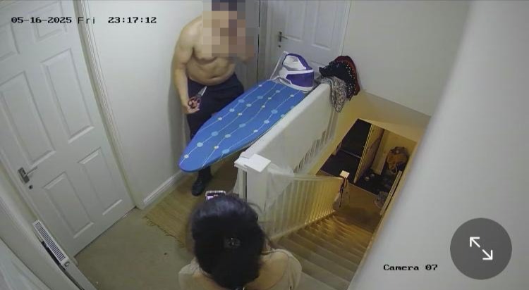 Security camera footage of a shirtless man in a home.