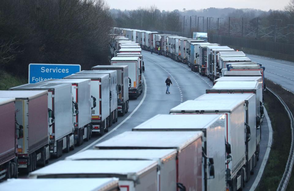 Long line of trucks on a highway.