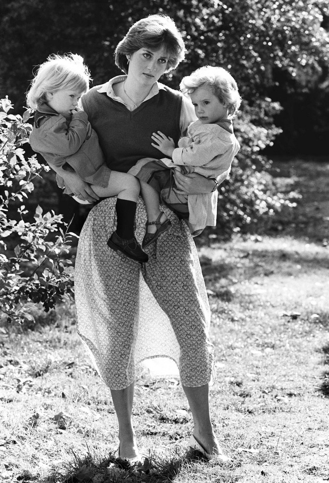 Princess Diana holding two young children.