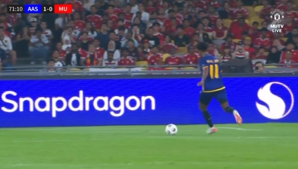 Soccer player running with the ball on the field.