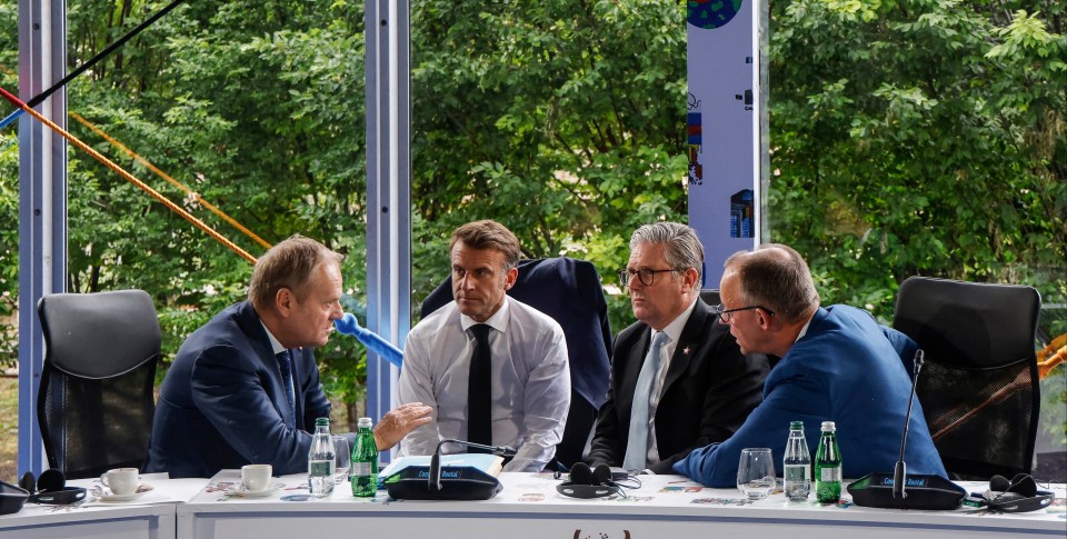 Photo of Donald Tusk, Emmanuel Macron, Keir Starmer, and Friedrich Merz at a meeting.