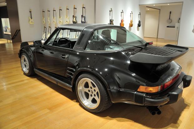 Black 1987 Porsche 930 Targa Turbo Flachbau on display.