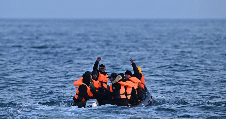 Migrants in a small inflatable boat crossing the English Channel.