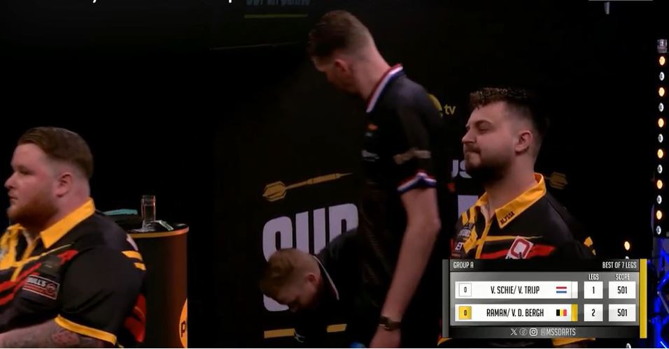 Darts players reacting to a fall.