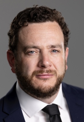 Headshot of a man in a suit.