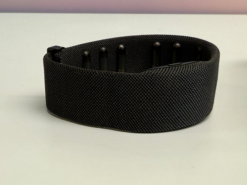 Black fabric headband with small black protrusions.