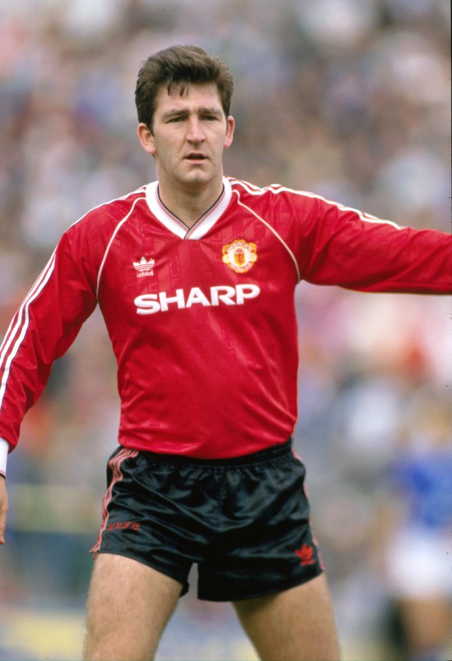 Norman Whiteside of Manchester United in a red jersey.