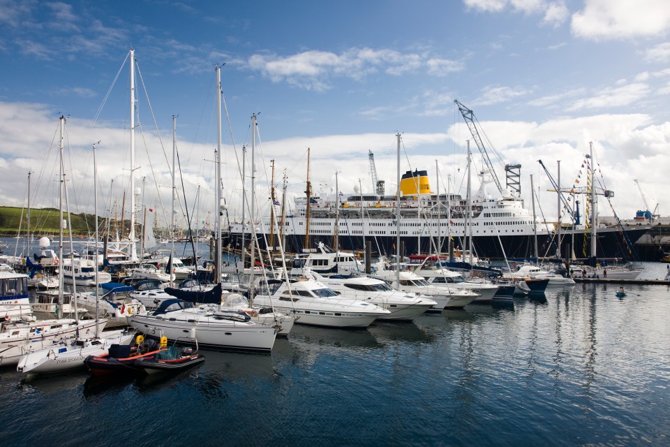 Harbor with many sailboats and a large ship.