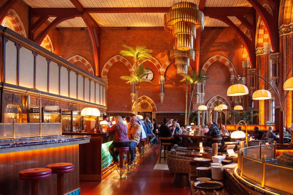 Bar and restaurant in a large, ornate space.