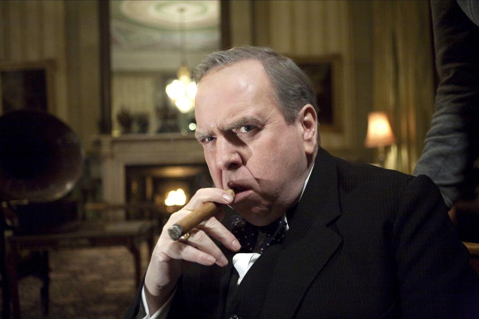 Timothy Spall in The King's Speech, smoking a cigar.