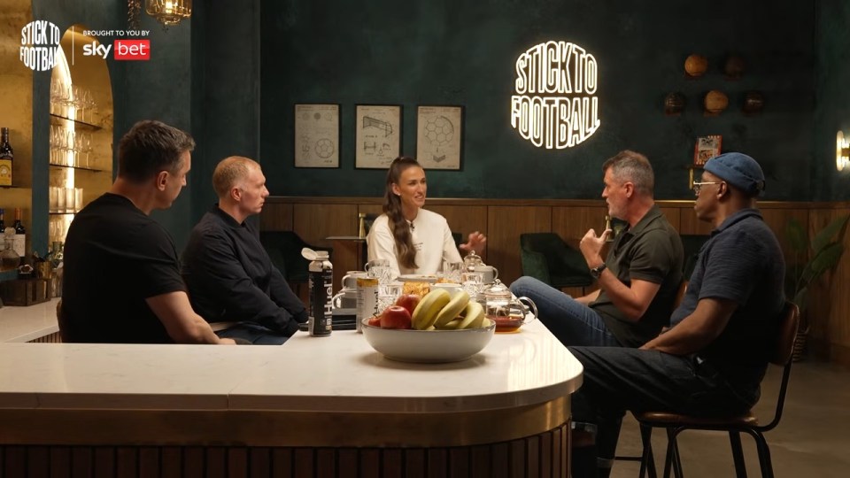 Four people sitting at a bar, talking.
