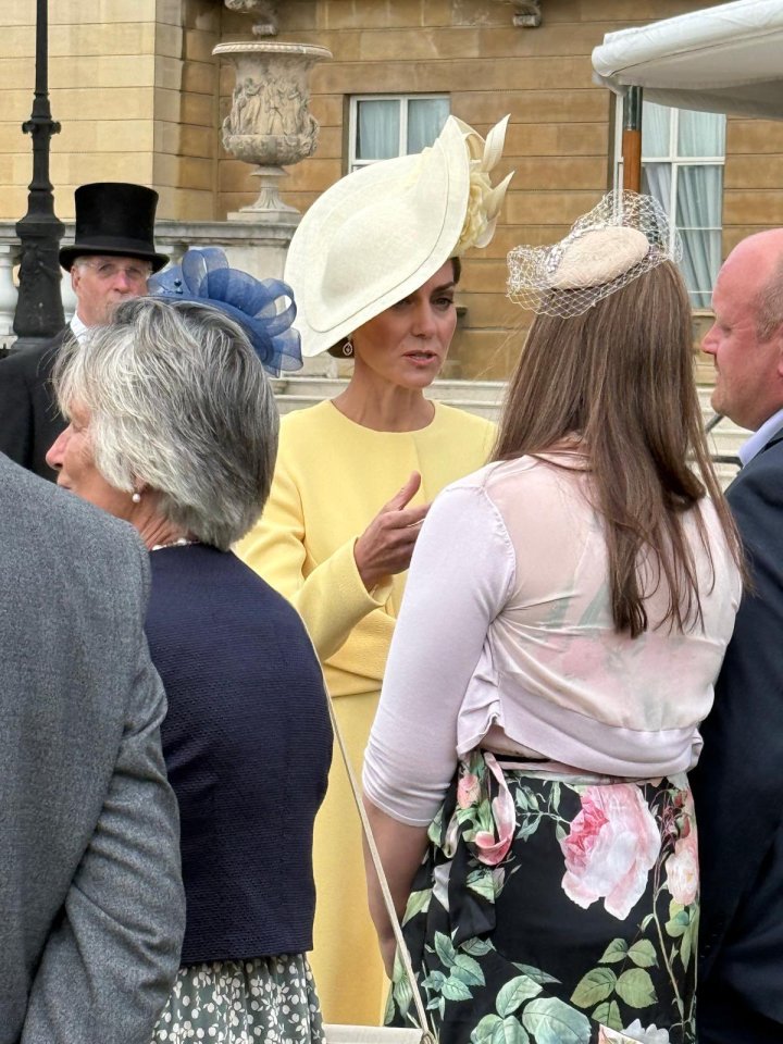 Kate Middleton in yellow dress speaking to guests.